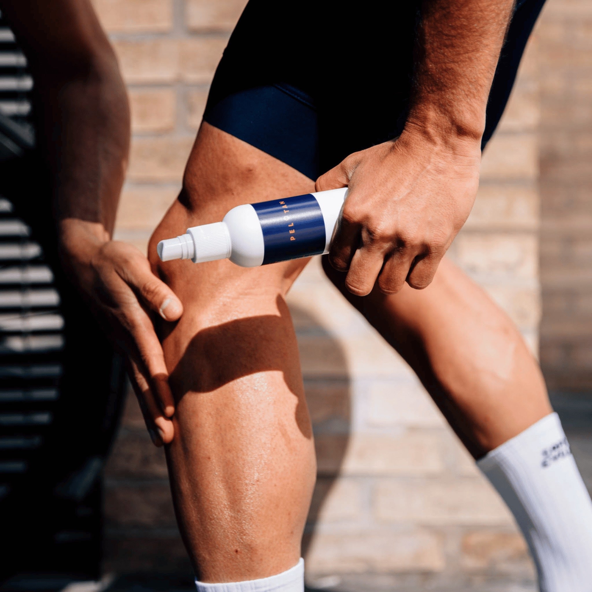 Person applying Pelotan to their lower legs.