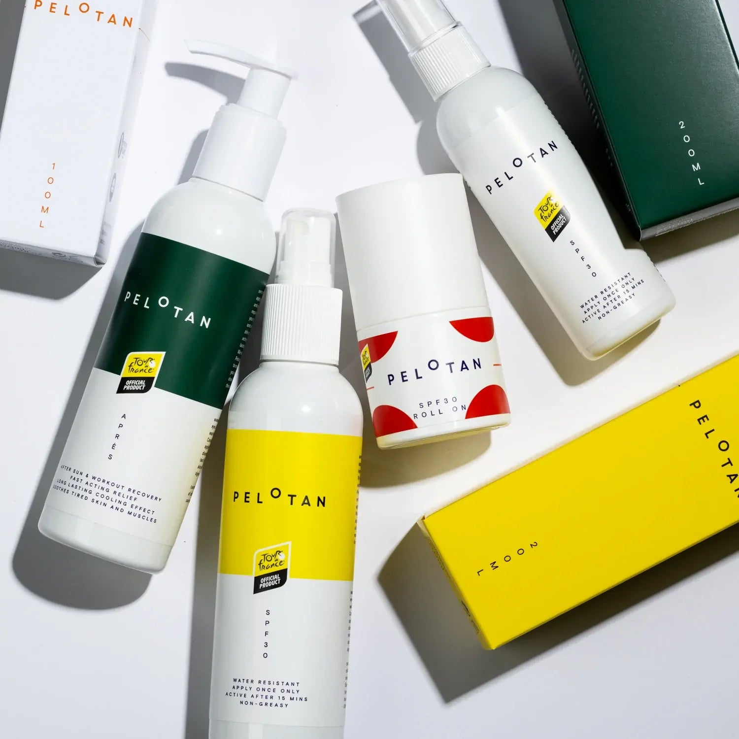 Bottles of Pelotan’s recovery and performance sunscreen products are laid on a white background, showing products that are official products of the Tour de France.