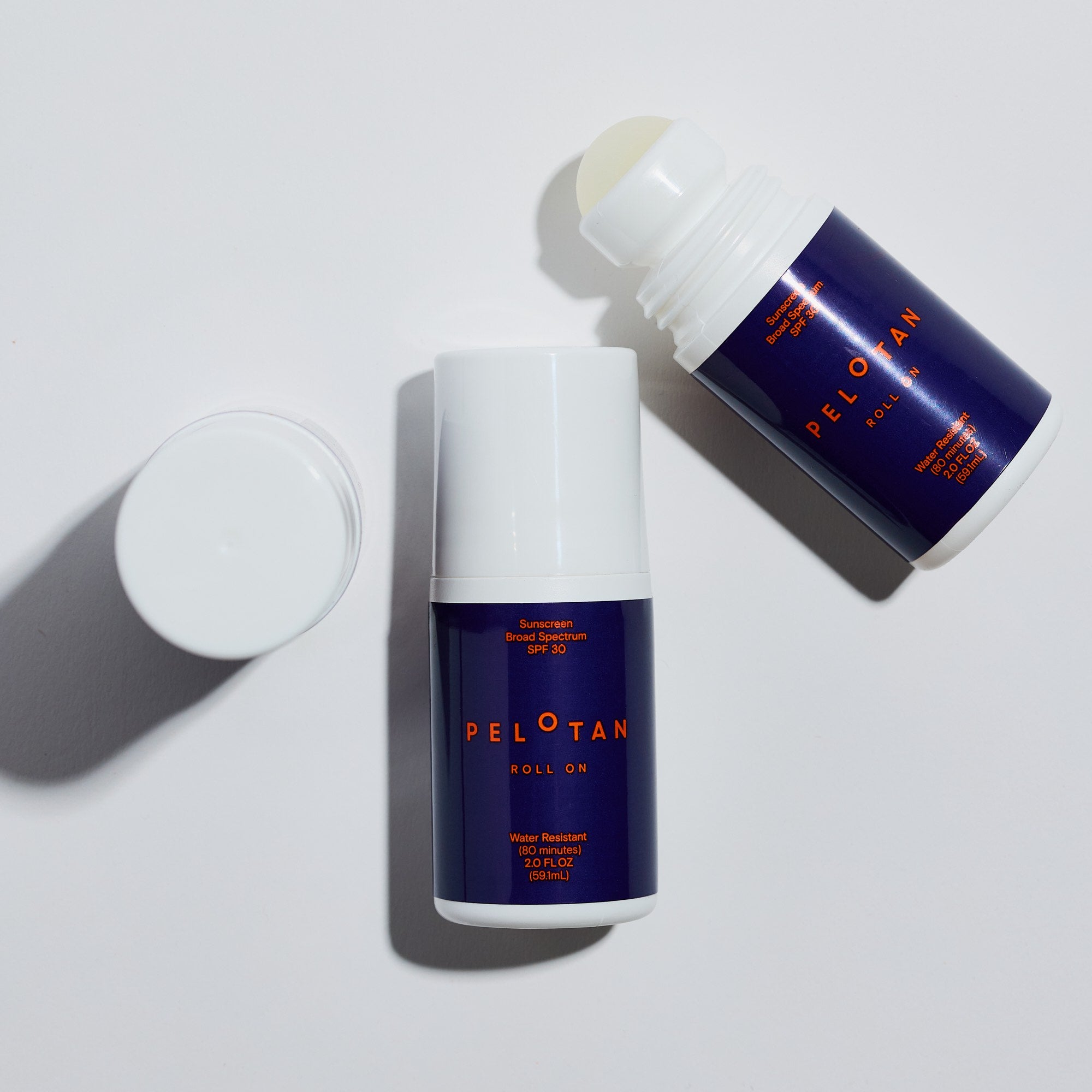 Two bottles of Pelotan roll-on product on a white background