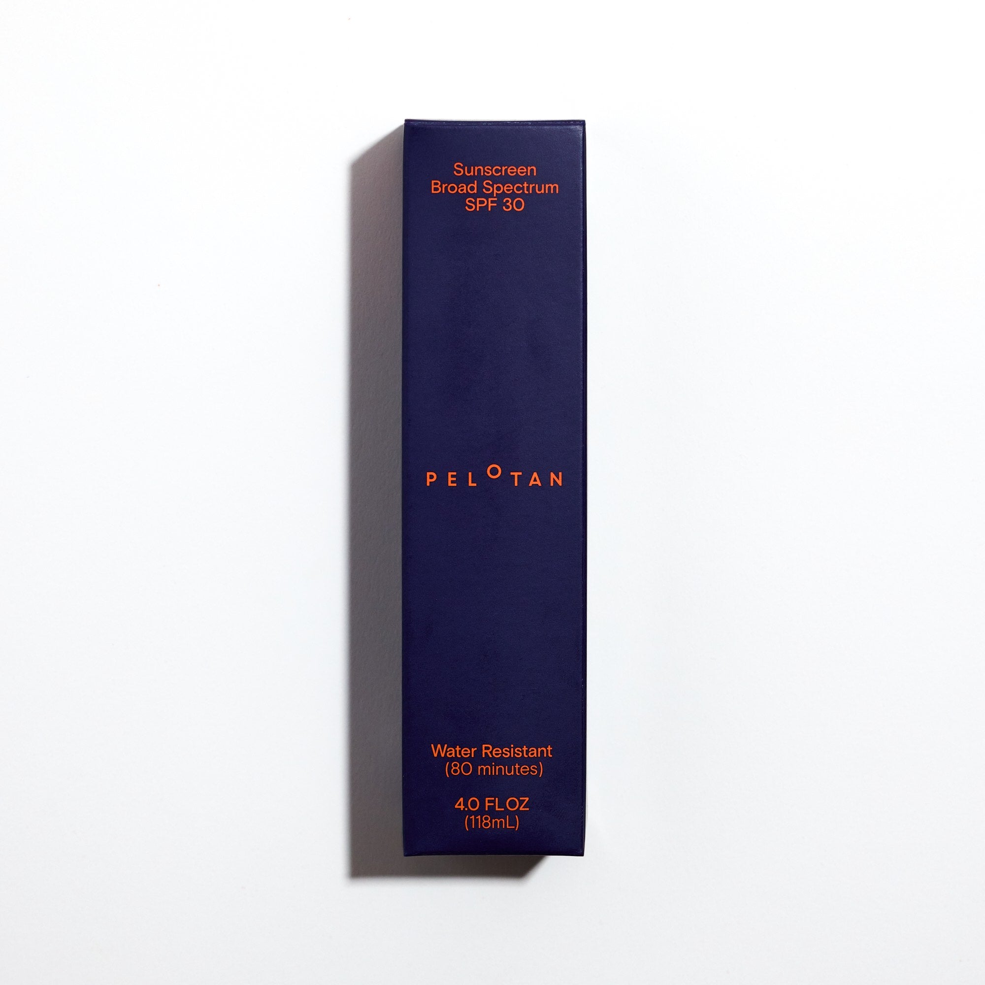 Navy blue sunscreen bottle with orange text on a white background