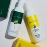 Two bottles of Peloton skincare products on a light background