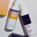 Two bottles of Pelotan skincare products on a light background